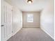 Neutral bedroom with carpet, freshly painted walls, and two closets at 8904 Creekwood Ct, Riverdale, GA 30274
