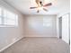 Neutral bedroom featuring a ceiling fan, a window, and a sliding door closet at 8904 Creekwood Ct, Riverdale, GA 30274