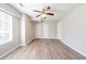 This bedroom has neutral walls, light-colored wood-look floors, and a ceiling fan with lights at 8904 Creekwood Ct, Riverdale, GA 30274
