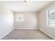 Neutral bedroom with carpet, freshly painted walls, and two windows at 8904 Creekwood Ct, Riverdale, GA 30274