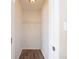 Small, walk-in closet with a single shelf and wood-look floors at 8904 Creekwood Ct, Riverdale, GA 30274
