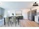 Dining area with a table and chairs, stainless steel refrigerator, and light wood floors at 8904 Creekwood Ct, Riverdale, GA 30274