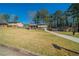 Split-level home with a well-manicured lawn and mature trees at 8904 Creekwood Ct, Riverdale, GA 30274