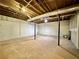 Unfinished basement featuring concrete floor, painted concrete walls, and exposed ceiling with black support beams at 93 Mill Creek Rd, Hiram, GA 30141