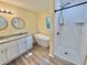 Bathroom featuring dual sinks, a modern soaking tub, a shower, granite countertops, and updated fixtures at 93 Mill Creek Rd, Hiram, GA 30141
