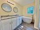 Bathroom featuring dual sinks, a modern soaking tub, granite countertops, and updated fixtures at 93 Mill Creek Rd, Hiram, GA 30141