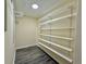 Walk-in closet featuring organized shelving for ample storage and dark flooring at 93 Mill Creek Rd, Hiram, GA 30141