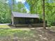 Charming single-story home with a covered front porch and a well-maintained lawn surrounded by lush trees at 93 Mill Creek Rd, Hiram, GA 30141