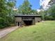 Exterior view of the house featuring a two-story deck, a walk-out basement, and verdant lawn at 93 Mill Creek Rd, Hiram, GA 30141