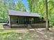 Charming single-story home with a covered front porch and a well-maintained lawn surrounded by lush trees at 93 Mill Creek Rd, Hiram, GA 30141