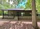 Inviting single-story house with a spacious covered porch and lattice accents, nestled among mature trees at 93 Mill Creek Rd, Hiram, GA 30141
