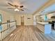 Spacious living area with stylish flooring leading to a kitchen island, complemented by abundant natural light at 93 Mill Creek Rd, Hiram, GA 30141