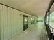 Long, covered porch featuring wood decking and a railing, providing an inviting outdoor space at 93 Mill Creek Rd, Hiram, GA 30141