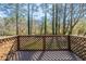 Wooden back deck with lattice railing overlooks lush, tall trees and foliage at 158 Polar Rock Sw Dr, Atlanta, GA 30315