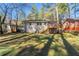 Spacious, grassy backyard features a deck and mature trees, perfect for relaxation and entertaining at 158 Polar Rock Sw Dr, Atlanta, GA 30315