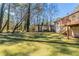 A large, grassy backyard with a deck and mature trees provides an inviting outdoor space at 158 Polar Rock Sw Dr, Atlanta, GA 30315