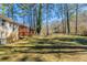 Exterior view of expansive backyard with a deck and lush tree line at 158 Polar Rock Sw Dr, Atlanta, GA 30315