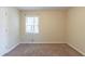 The bedroom has light beige carpet, window with blinds, and walls painted in neutral colors at 158 Polar Rock Sw Dr, Atlanta, GA 30315