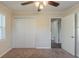 Cozy bedroom featuring a ceiling fan, closet, neutral carpet and ample natural light at 158 Polar Rock Sw Dr, Atlanta, GA 30315