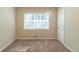 A clean bedroom features a light beige carpet, a window with blinds, and neutral wall color at 158 Polar Rock Sw Dr, Atlanta, GA 30315