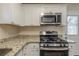 Stylish kitchen showcases stainless steel appliances, modern granite counters, and ample counter space at 158 Polar Rock Sw Dr, Atlanta, GA 30315
