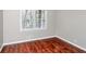 Bright bedroom features wood floors, a large window, and neutral paint at 664 S Indian Creek Dr, Stone Mountain, GA 30083