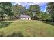 Expansive green backyard features fenced area, outbuilding, and mature trees for added privacy at 1240 Evans Cook Rd, Canton, GA 30115