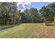 Expansive, grassy backyard with mature trees provides privacy and a picturesque setting at 1240 Evans Cook Rd, Canton, GA 30115