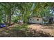 Beautiful backyard with mature trees providing plenty of shade and a storage shed at 1240 Evans Cook Rd, Canton, GA 30115