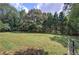 Expansive backyard with mature trees and a wooden fence adding privacy to the property at 1240 Evans Cook Rd, Canton, GA 30115