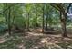 Large wooded backyard with storage shed, playhouse, privacy fence, and trampoline at 1240 Evans Cook Rd, Canton, GA 30115