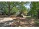 Well-maintained backyard with driveway, mature trees, and split rail fence for added privacy at 1240 Evans Cook Rd, Canton, GA 30115