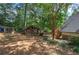 Lush backyard featuring a quaint shed, wooden steps, and mature trees creating a serene and private outdoor space at 1240 Evans Cook Rd, Canton, GA 30115