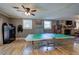 Basement with a ping pong table, wooden floors, and a large ceiling fan at 1240 Evans Cook Rd, Canton, GA 30115