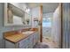 Charming bathroom with wood accents, beadboard, and a white vanity, offering a blend of rustic and modern design at 1240 Evans Cook Rd, Canton, GA 30115