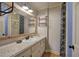 Bathroom features granite countertops, a decorative mirror, and blue patterned shower curtain at 1240 Evans Cook Rd, Canton, GA 30115