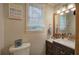 Well-lit bathroom features a modern vanity, decorative sign, and natural light from the window at 1240 Evans Cook Rd, Canton, GA 30115