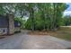 Long driveway leading to a home with stone accents and mature trees, offering privacy and curb appeal at 1240 Evans Cook Rd, Canton, GA 30115