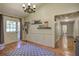 Cozy entryway with a patterned rug, decorative wall shelves, and natural light from the front door at 1240 Evans Cook Rd, Canton, GA 30115