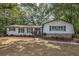 Charming one-story home with stone accents, surrounded by mature trees and landscaping at 1240 Evans Cook Rd, Canton, GA 30115