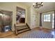 Entryway featuring hardwood floors, elegant chandelier, and a view into the cozy living room with a stone fireplace at 1240 Evans Cook Rd, Canton, GA 30115