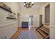 Inviting foyer featuring hardwood floors, a decorative chandelier, and a staircase leading to the upper level at 1240 Evans Cook Rd, Canton, GA 30115