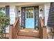 Charming home entrance with a light blue door and matching sidelights, enhanced by potted flowers and a welcoming mat at 1240 Evans Cook Rd, Canton, GA 30115