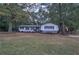 Quaint house featuring a stone facade, symmetrical windows, and a manicured front yard for classic curb appeal at 1240 Evans Cook Rd, Canton, GA 30115