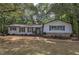 Charming single-story home with stone accents, complemented by mature trees and a well-manicured front lawn at 1240 Evans Cook Rd, Canton, GA 30115