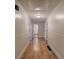 Long hallway featuring hardwood floors, with bathroom visible at the end of the hall at 1240 Evans Cook Rd, Canton, GA 30115