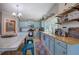 Cozy kitchen featuring light blue cabinets, butcher block counters, and stainless steel appliances at 1240 Evans Cook Rd, Canton, GA 30115