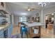 Kitchen view showcasing wood floors, light blue cabinets, island, and stainless appliances at 1240 Evans Cook Rd, Canton, GA 30115