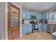 Stylish kitchen with blue cabinets, granite countertops, stainless steel appliances, and wood floors at 1240 Evans Cook Rd, Canton, GA 30115