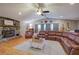 Comfortable living room featuring wood burning fireplace, hardwood floors, and cozy leather seating at 1240 Evans Cook Rd, Canton, GA 30115